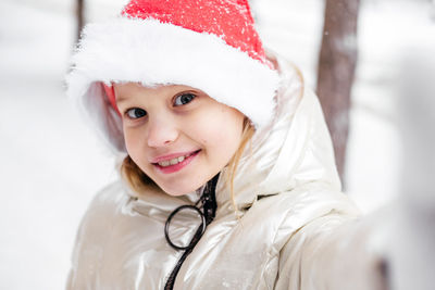 Portrait of smiling girl wearing santa hat