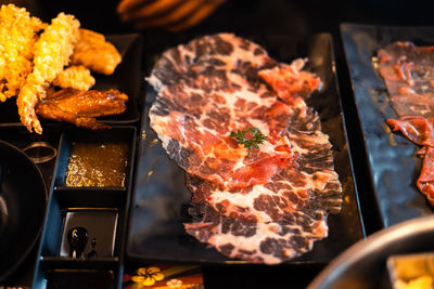 High angle view of meat on barbecue grill