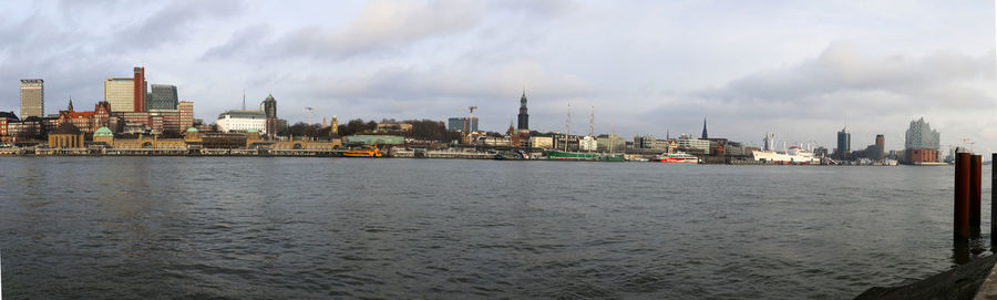 Panoramic view of sea and buildings against sky