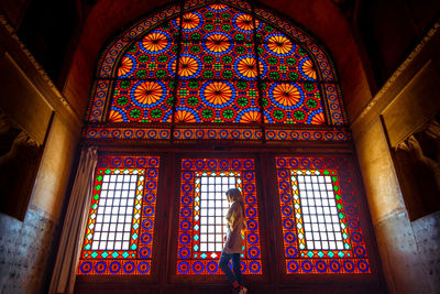 Low angle view of stained glass window in building