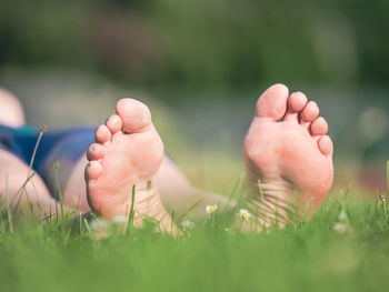 Close-up of human feet on field