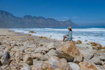 Rear view of man standing on beach