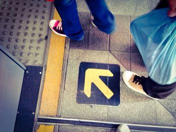 Low section of woman standing on tiled floor