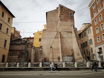 People walking on street amidst buildings in city