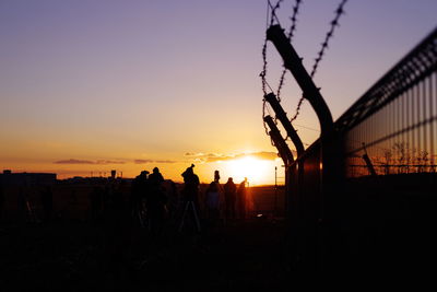 Silhouette of people at sunset