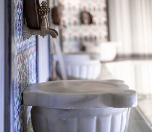 Close-up of water flowing through faucet