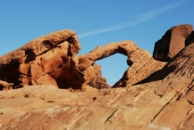 Low angle view of rock formations against blue sky