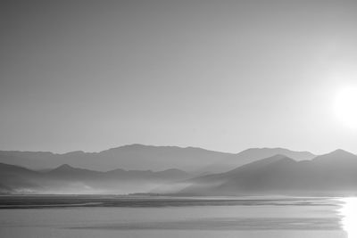 Scenic view of lake and mountains against sky