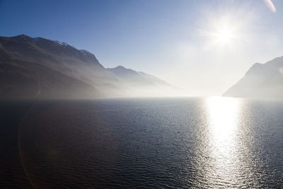 Scenic view of mountains against bright sun