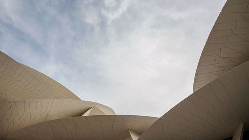 Low angle view of building against cloudy sky