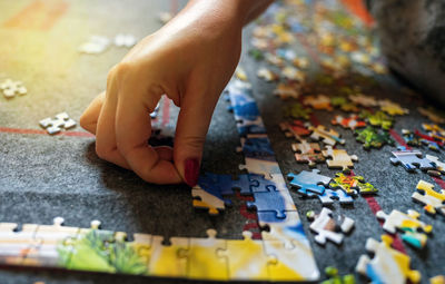 Close-up of person playing with multi colored lights