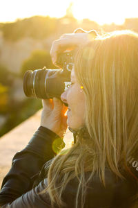 Portrait of woman holding camera