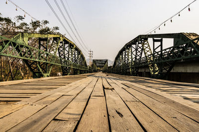 Surface level of footbridge against clear sky