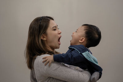 Side view of mother and daughter
