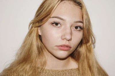 Close-up portrait of beautiful woman over white background