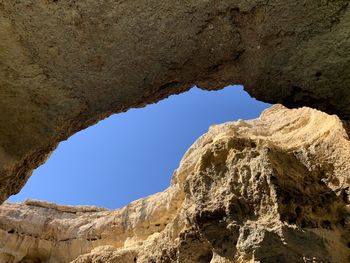 Low angle view of rock formation against sky