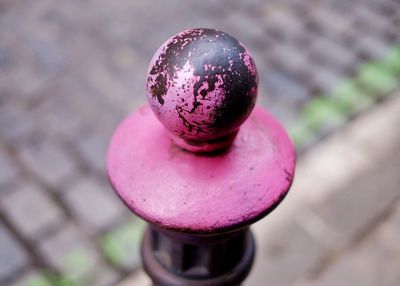 Close-up of rusty metallic bollard on sidewalk