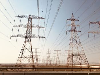 Low angle view of electricity pylon against sky