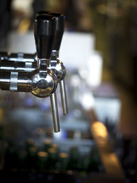 Close-up of beer taps at bar