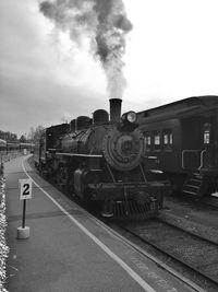 Train on railroad tracks against sky