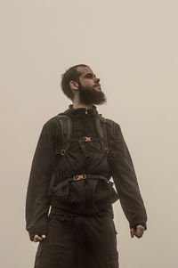 Young man looking away against white background