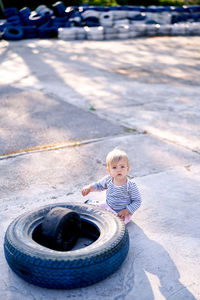 High angle view of boy sitting in car