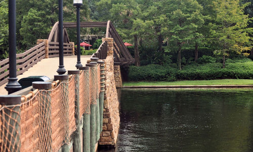 Footbridge over lake in forest