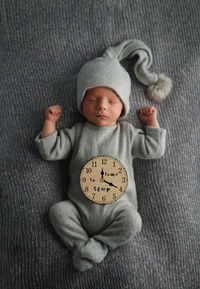 Cute newborn baby sleeping on gray blanket and holding craft wooden star. bed vibes.