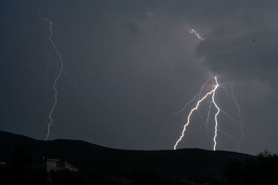Low angle view of lightning against sky at night