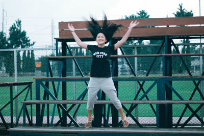 Portrait of man standing on railing