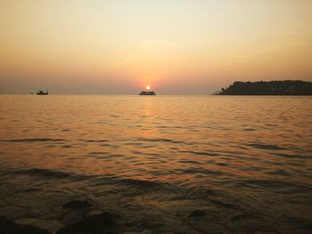 Scenic view of sea against orange sky