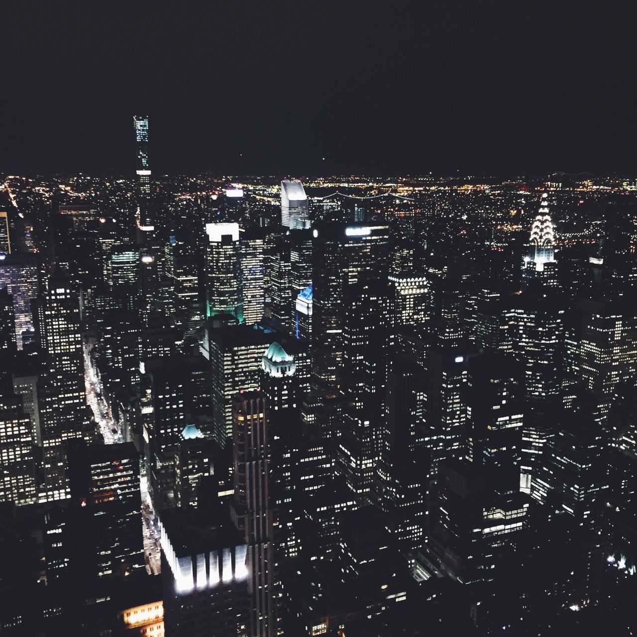 ILLUMINATED CITYSCAPE AGAINST SKY