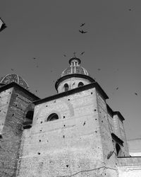 Low angle view of bell tower against sky