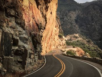 Road amidst mountains against sky