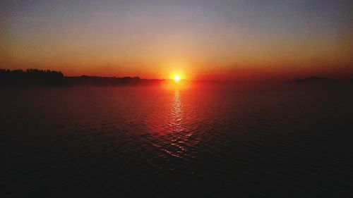 Scenic view of sea against romantic sky at sunset