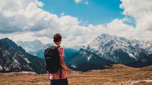 Man standing on mountain against sky