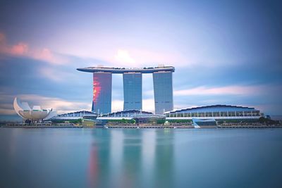 Marina bay sands and artscience against cloudy sky during sunset