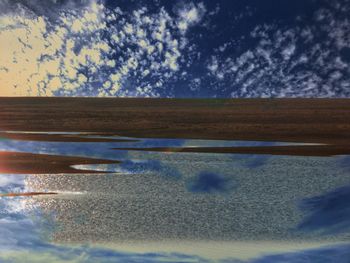 Digital composite image of water on land against sky