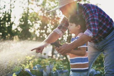 Father and son on plant