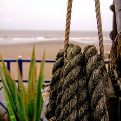 Close-up of rope tied up on beach