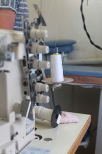 Close-up of sewing machinery at table