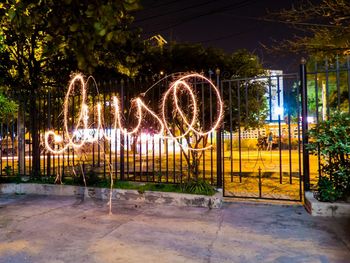 View of illuminated gate at night