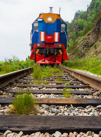 Train on railroad track against sky