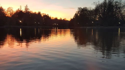 Scenic view of lake against sky at sunset