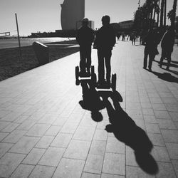 People walking on footpath in city