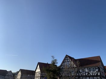Low angle view of traditional german buildings against blue sky