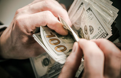 Close-up of hand holding paper currency