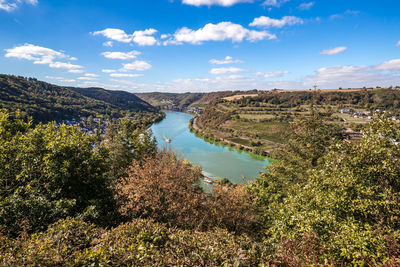 High angle view of river amidst trees against sky