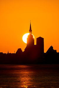 Scenic view of sea against orange sky