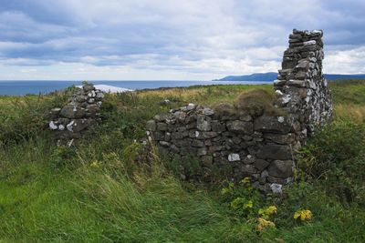 Stone stack on field against sky